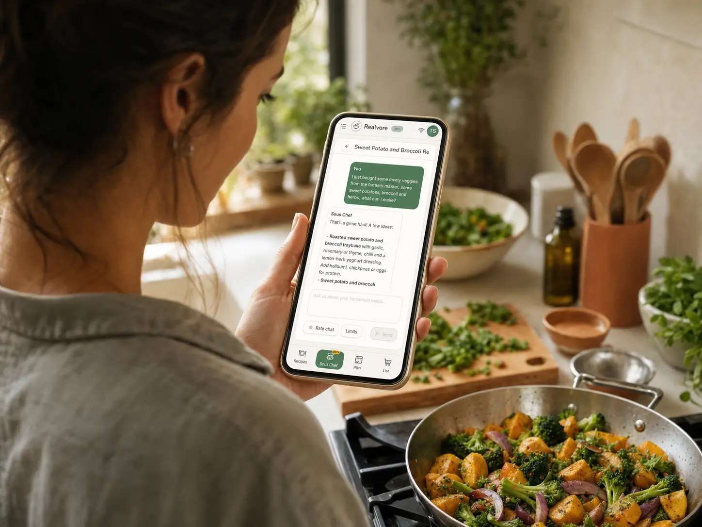 A home cook viewing the Sous Chef app while preparing dinner